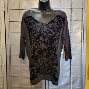 Loft medium black top with 3/4 sleeves, V neck and flock print on front.